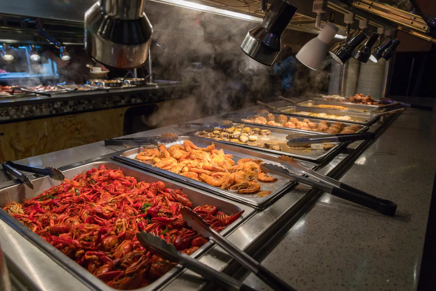 Steaming seafood buffet with crawfish, shrimp, mussels, and other dishes